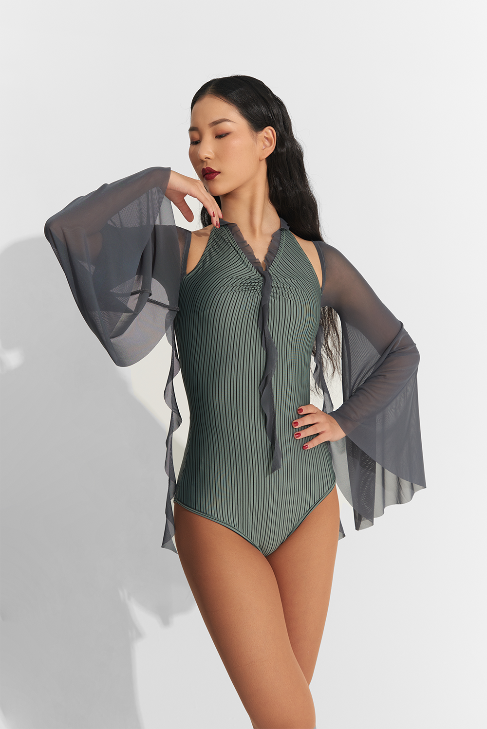 Introducing the DANCE QUEEN 767 Lantern sleeve Leotard, in a stunning dark cyan color. Designed for ultimate freedom and grace, this leotard features elegant lantern sleeves that will make you feel like a true dance queen. Elevate your performance with this luxurious and exclusive piece.