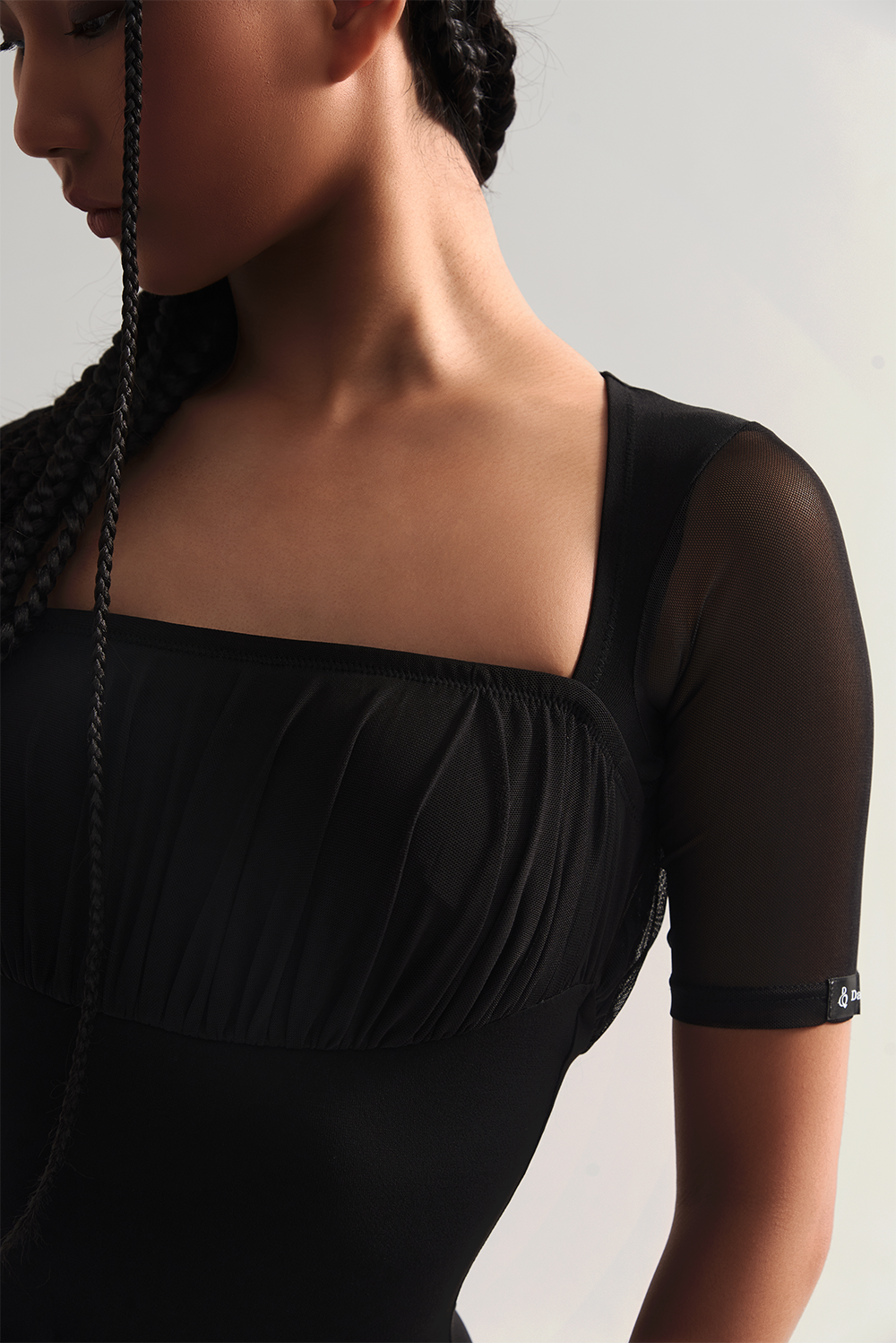 The DANCE QUEEN 713 Square Neck Short Sleeve Black Leotard is a professional and sleek option for dancers. With a square neck and short sleeves, this leotard provides a comfortable and stylish fit.