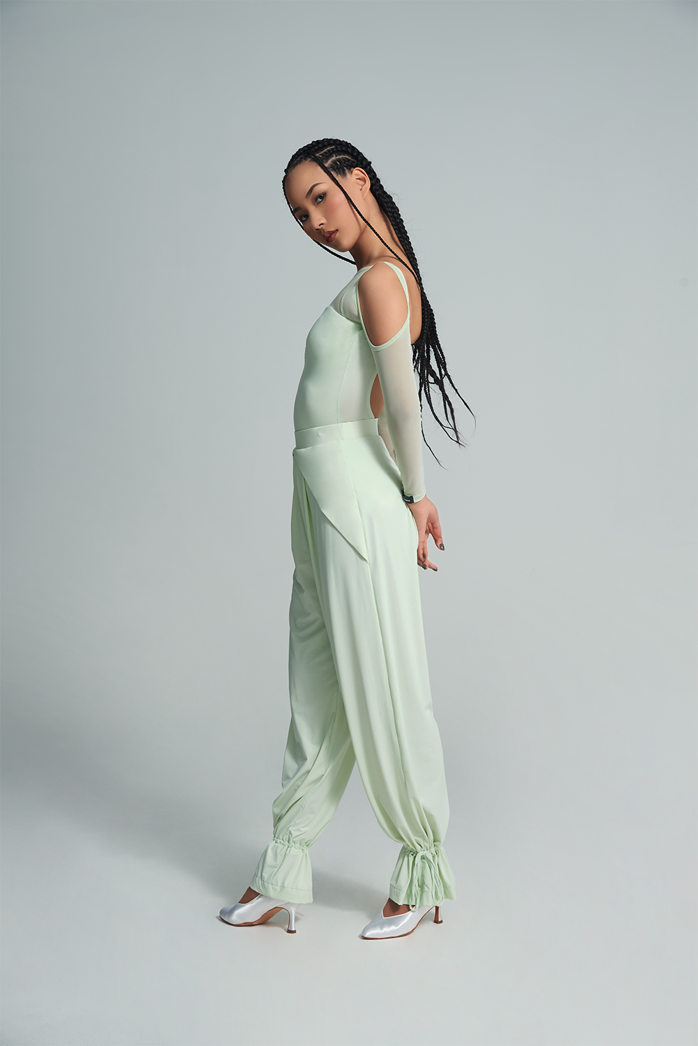 Experience the versatility and style of the DANCE QUEEN 650B-2 Mint Mambo Top Cape Set. This two-piece set can be worn alone for a sleek and elegant look or layered for added dimension. Show off your dance moves with confidence and grace in this ballroom leotard.