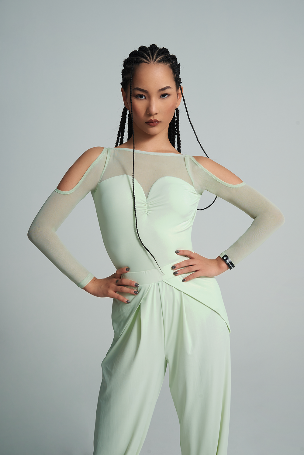 Experience the versatility and style of the DANCE QUEEN 650B-2 Mint Mambo Top Cape Set. This two-piece set can be worn alone for a sleek and elegant look or layered for added dimension. Show off your dance moves with confidence and grace in this ballroom leotard.