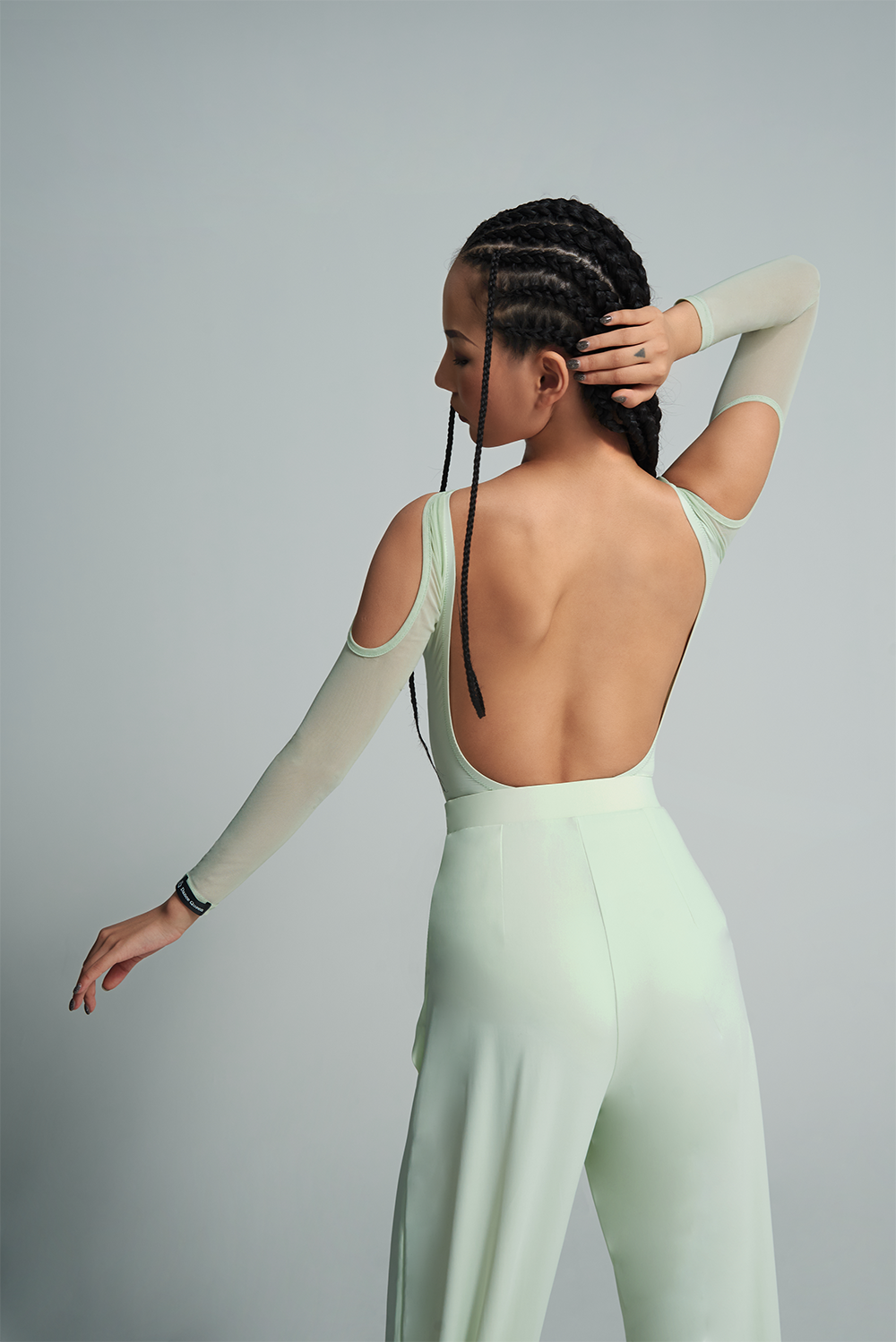 Experience the versatility and style of the DANCE QUEEN 650B-2 Mint Mambo Top Cape Set. This two-piece set can be worn alone for a sleek and elegant look or layered for added dimension. Show off your dance moves with confidence and grace in this ballroom leotard.