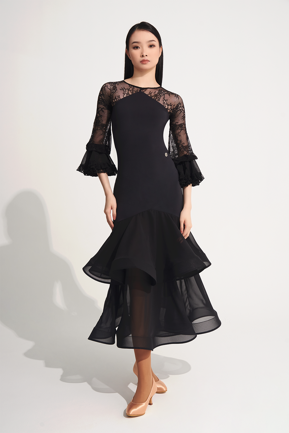 DANCE QUEEN 719 Ruffle Black Lace Sleeve Custom Dress This custom dress features ruffle and lace details that exude confidence and style.&nbsp;