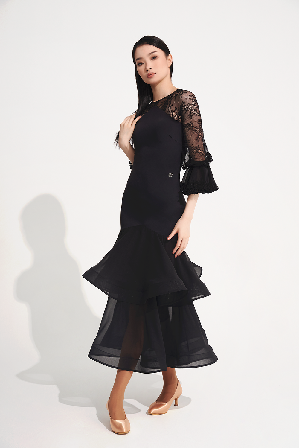 DANCE QUEEN 719 Ruffle Black Lace Sleeve Custom Dress This custom dress features ruffle and lace details that exude confidence and style.&nbsp;