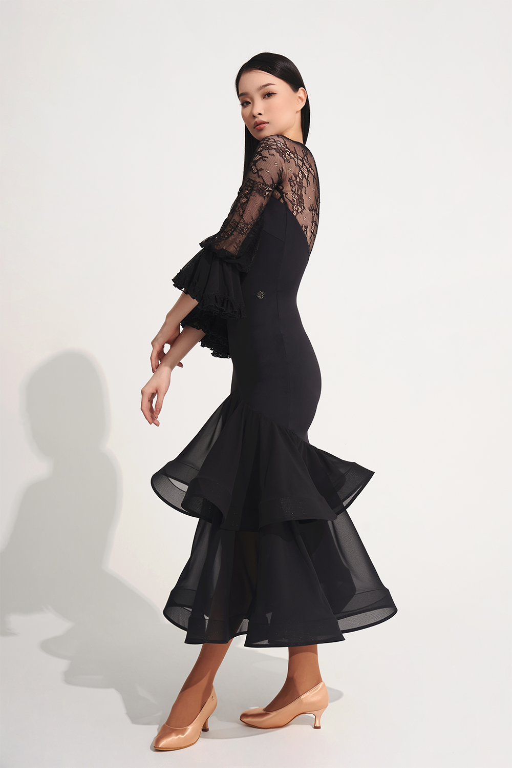 DANCE QUEEN 719 Ruffle Black Lace Sleeve Custom Dress This custom dress features ruffle and lace details that exude confidence and style.&nbsp;