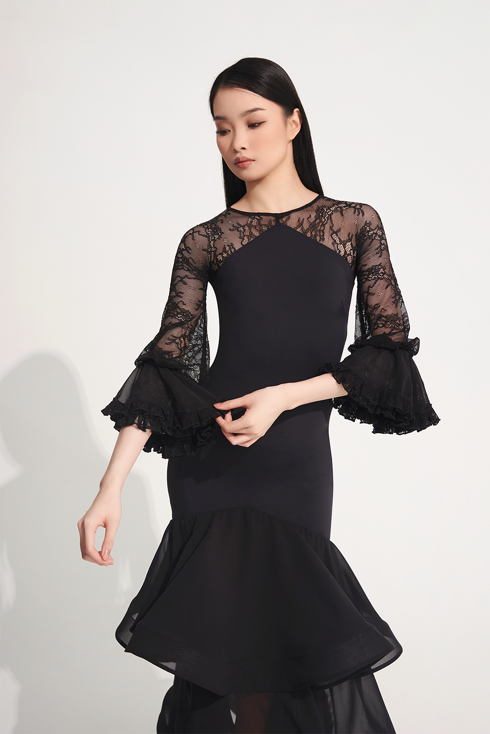 DANCE QUEEN 719 Ruffle Black Lace Sleeve Custom Dress This custom dress features ruffle and lace details that exude confidence and style.&nbsp;